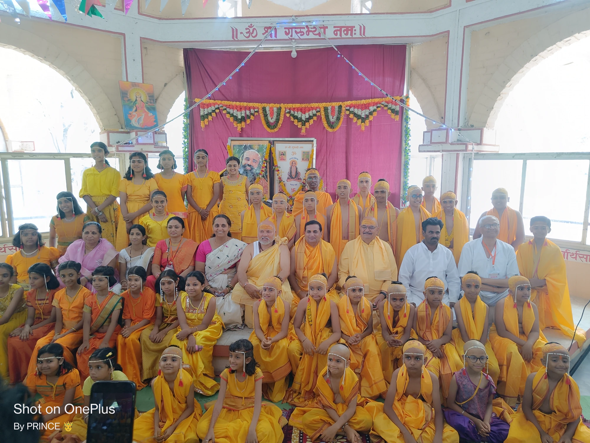Upanayan batch group photo in yellow dhotis